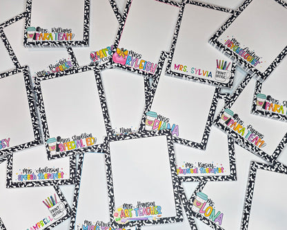 a collection of personalized A2 sized notepads, each with a unique name and title. The nameplates are arranged in a grid-like pattern, with each one featuring a different name and title. The names and titles are written in a variety of fonts and colors, creating a visually appealing and diverse display. These are teacher themed notepads with vibrant colors, most being in neon or bright rainbow patterns.