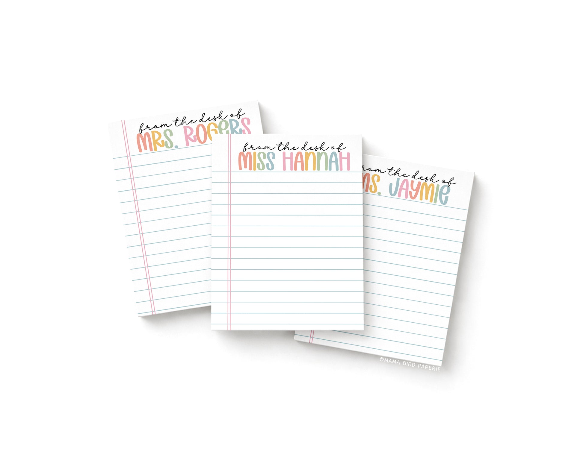 Three small notepads with notebook paper background. There are personalized names at the top of each notepad in bolder pastel rainbow text with "from the desk of" in black cursive above the rainbow pastel text.